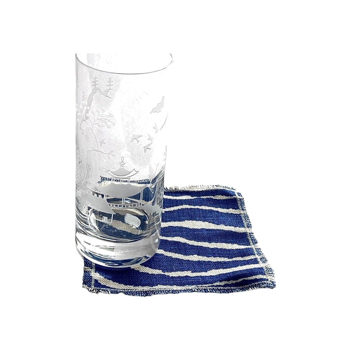 Danielle Rollins for J. Earl & Sons highball glass on a navy striped napkin