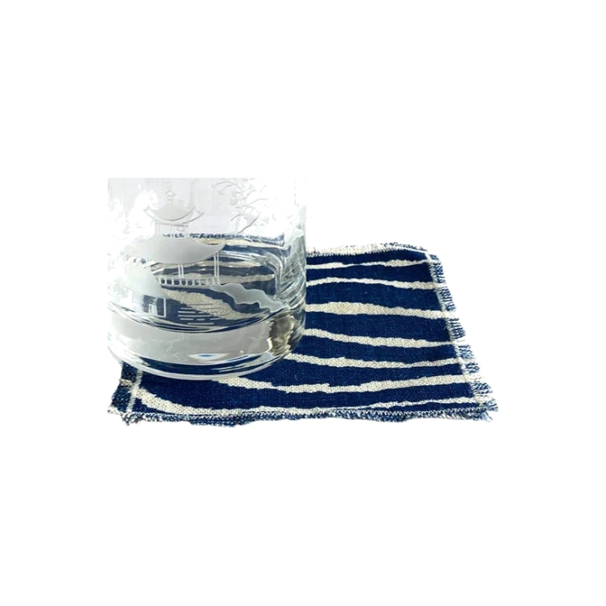 Danielle Rollins for J. Earl & Sons double old fashioned glass on a navy striped napkin