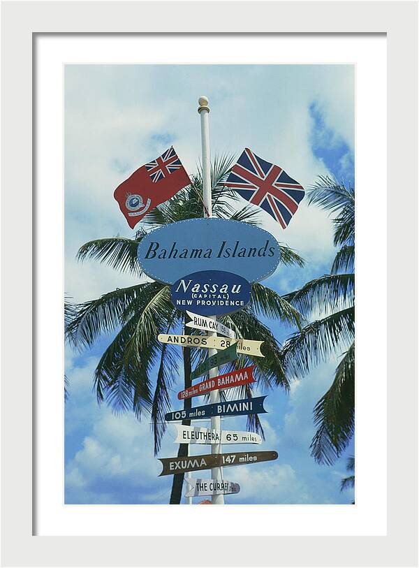Bahamas Signpost by Slim Aarons, 8" x 12", white frame and white mat