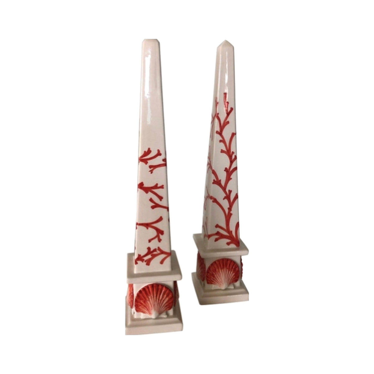 A Pair of Ceramic Coral & Shell Design Obelisks on a white background